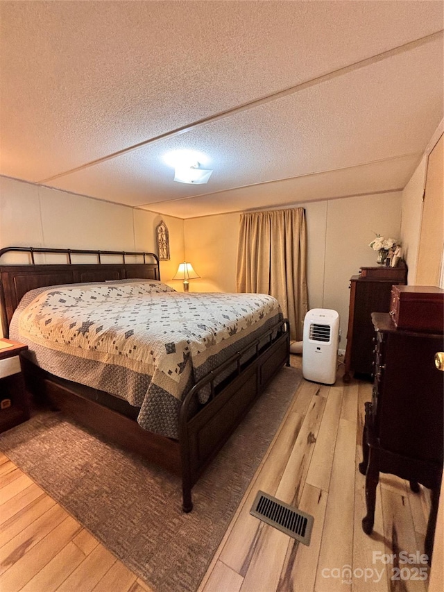 1890 Bud Tilley Rd, Pinnacle, NC 27043 - bedroom with light wood-style floors and a textured ceiling