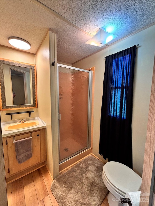 1890 Bud Tilley Rd, Pinnacle, NC 27043 - full bathroom with a textured ceiling, a stall shower, vanity, and wood finished floors