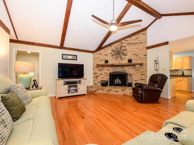 1047 Honeybee Trl, Fort Mill, SC 29715 - living room featuring light wood-style floors, ceiling fan, beamed ceiling, a brick fireplace, and high vaulted ceiling