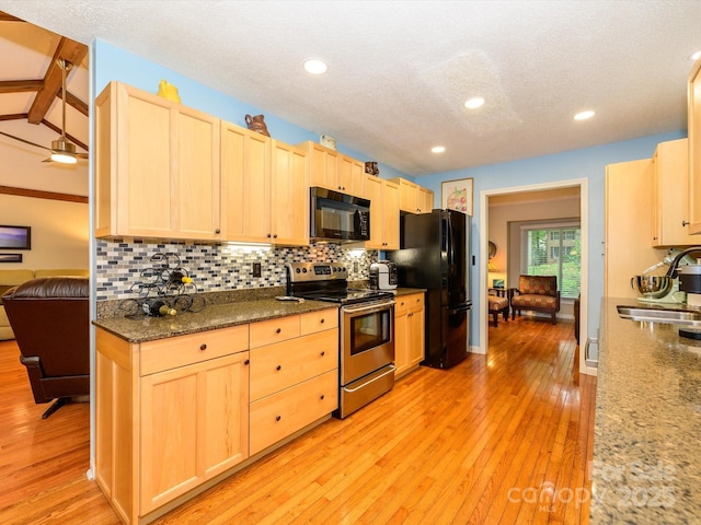 1047 Honeybee Trl, Fort Mill, SC 29715 - kitchen with black appliances, light brown cabinetry, decorative backsplash, light wood finished floors, and a textured ceiling