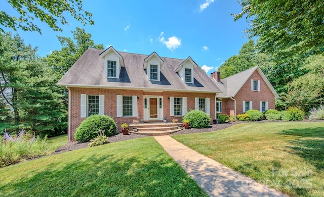 74 Challedon Dr, Candler, NC 28715 - new england style home with brick siding and a front lawn