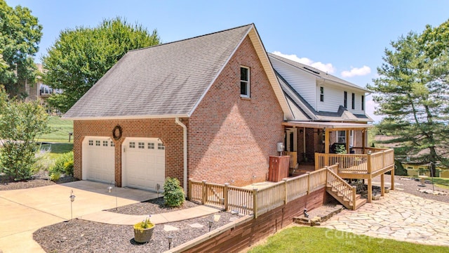 74 Challedon Dr, Candler, NC 28715 - view of side of property featuring brick siding, roof with shingles, a garage, and a porch
