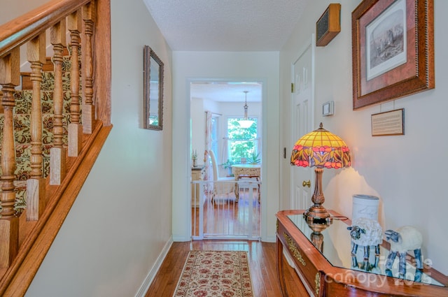 74 Challedon Dr, Candler, NC 28715 - corridor with stairs, wood finished floors, and a textured ceiling