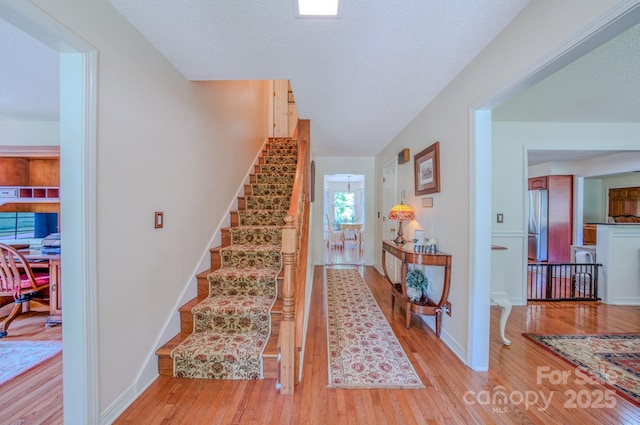 74 Challedon Dr, Candler, NC 28715 - stairs featuring wood finished floors and baseboards