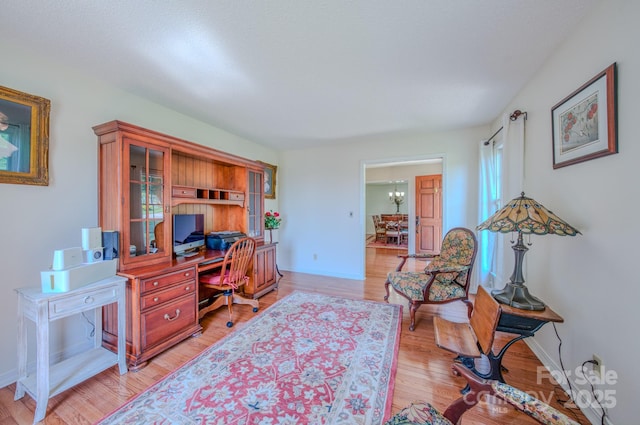 74 Challedon Dr, Candler, NC 28715 - home office with light wood-style floors and a chandelier