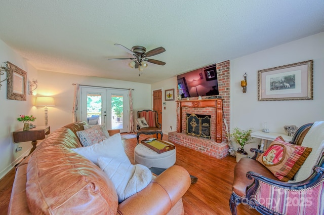 74 Challedon Dr, Candler, NC 28715 - living room featuring french doors, ceiling fan, wood finished floors, a brick fireplace, and a textured ceiling
