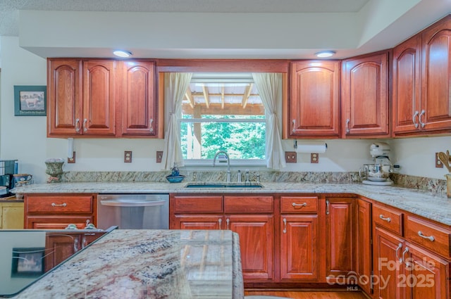74 Challedon Dr, Candler, NC 28715 - kitchen featuring dishwasher, light stone countertops, brown cabinetry, and wood finished floors