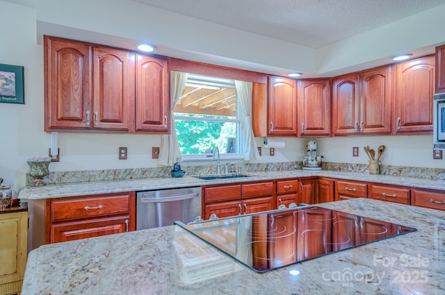 74 Challedon Dr, Candler, NC 28715 - kitchen featuring stainless steel appliances, light stone counters, brown cabinetry, and a textured ceiling