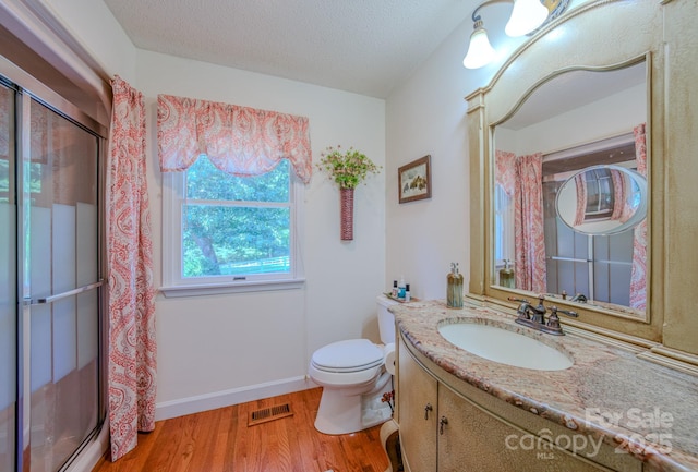 74 Challedon Dr, Candler, NC 28715 - full bath featuring wood finished floors, a stall shower, vanity, and a textured ceiling