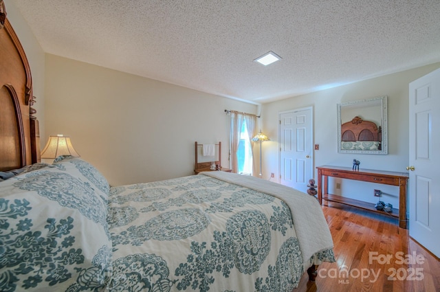 74 Challedon Dr, Candler, NC 28715 - bedroom with wood finished floors and a textured ceiling