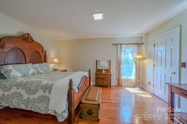 74 Challedon Dr, Candler, NC 28715 - bedroom with wood finished floors and a textured ceiling