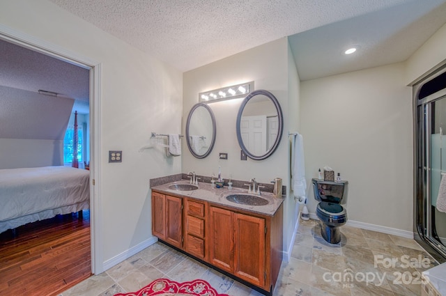 74 Challedon Dr, Candler, NC 28715 - bathroom with a textured ceiling, double vanity, and connected bathroom