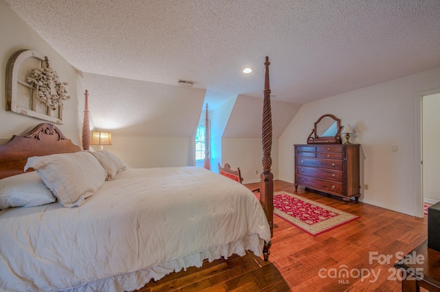 74 Challedon Dr, Candler, NC 28715 - bedroom featuring a textured ceiling, wood finished floors, lofted ceiling, and recessed lighting