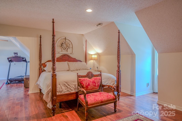 74 Challedon Dr, Candler, NC 28715 - bedroom featuring a textured ceiling, hardwood / wood-style flooring, vaulted ceiling, and recessed lighting