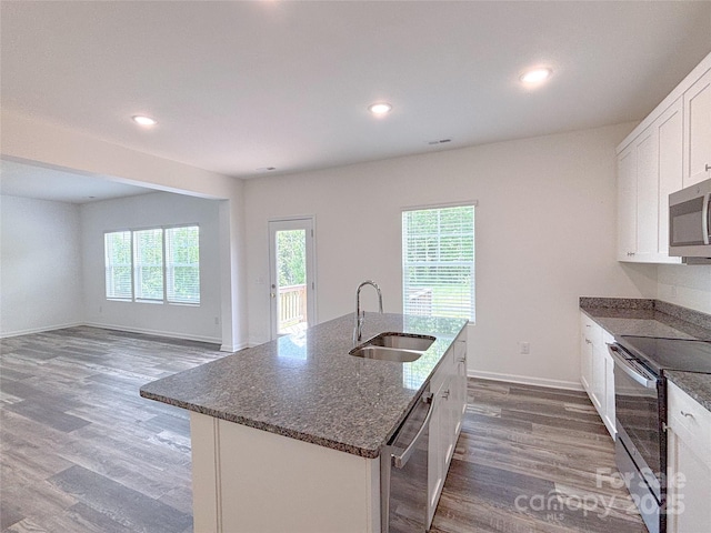 1542 Antioch Dr, Conover, NC 28613 - kitchen with stainless steel appliances, wood finished floors, dark stone counters, white cabinets, and recessed lighting