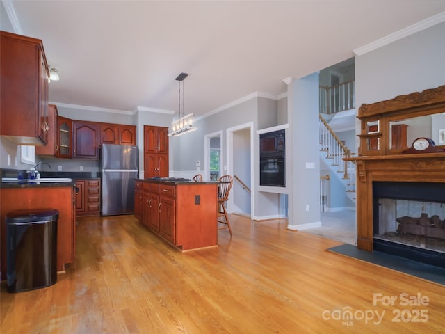 6620 Amos Smith Rd, Charlotte, NC 28214 - kitchen with freestanding refrigerator, dark countertops, light wood finished floors, glass insert cabinets, and crown molding
