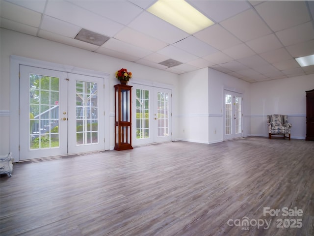 6620 Amos Smith Rd, Charlotte, NC 28214 - unfurnished living room featuring french doors, a paneled ceiling, and wood finished floors