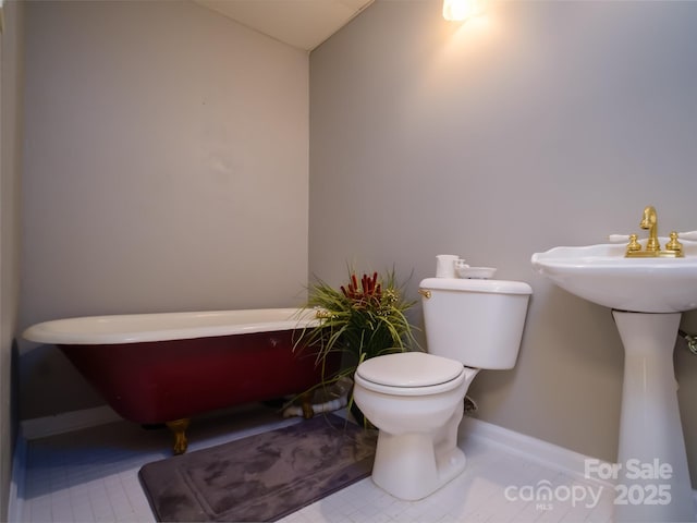 6620 Amos Smith Rd, Charlotte, NC 28214 - bathroom featuring a freestanding bath and baseboards