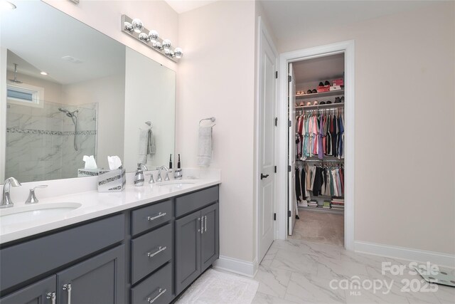 10240 Superb Ln, Charlotte, NC 28215 - bathroom featuring marble look tiles, a marble finish shower, double vanity, and a walk in closet