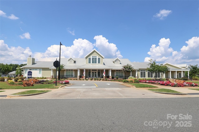 10240 Superb Ln, Charlotte, NC 28215 - view of front facade with uncovered parking, a metal roof, and a chimney