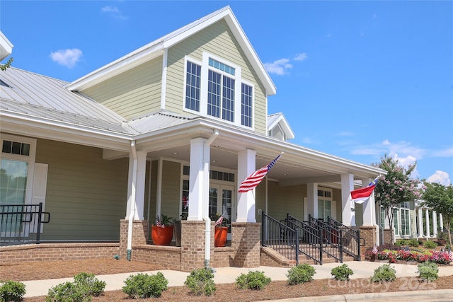 10240 Superb Ln, Charlotte, NC 28215 - view of front of home with a porch, a metal roof, and brick siding
