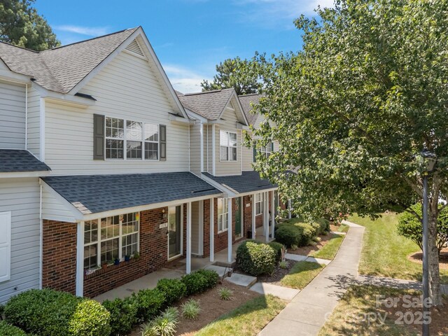 1778 Pergola Pl, Charlotte, NC 28213 - view of property with brick siding, roof with shingles, and covered porch