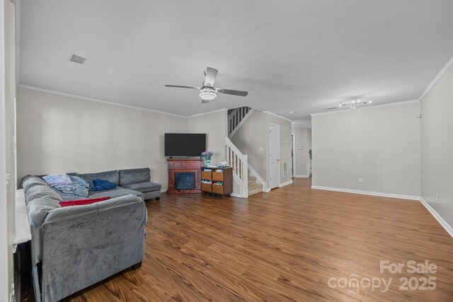 1778 Pergola Pl, Charlotte, NC 28213 - living room with stairway, crown molding, a ceiling fan, and wood finished floors