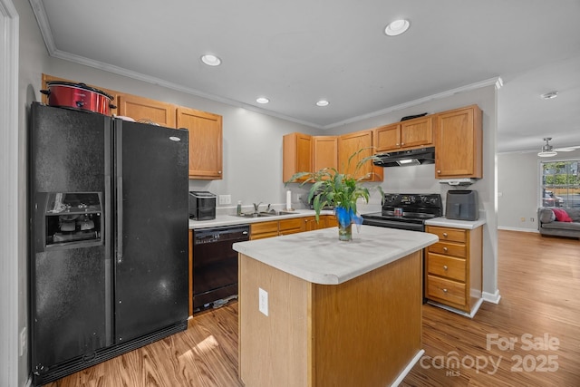 1778 Pergola Pl, Charlotte, NC 28213 - kitchen featuring black appliances, under cabinet range hood, crown molding, light countertops, and light wood finished floors