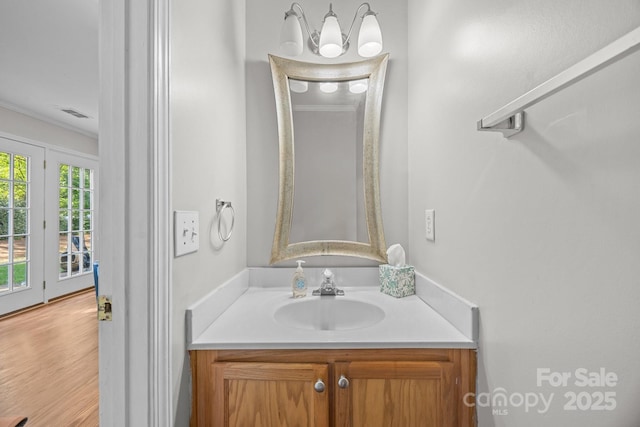 1778 Pergola Pl, Charlotte, NC 28213 - bathroom with ornamental molding, vanity, and wood finished floors