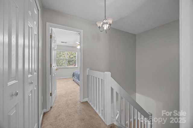 1778 Pergola Pl, Charlotte, NC 28213 - hallway with an upstairs landing, light colored carpet, and a chandelier