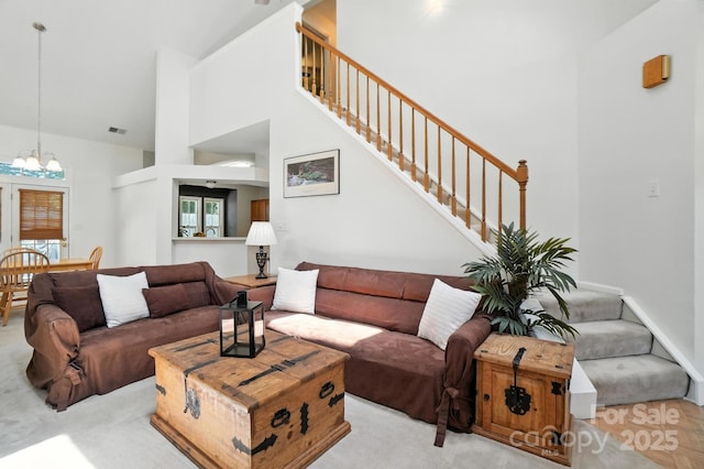 3325 Fortis Ln, Matthews, NC 28105 - living room with stairs, a chandelier, and a towering ceiling