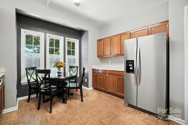 3325 Fortis Ln, Matthews, NC 28105 - kitchen with stainless steel fridge, brown cabinets, and light countertops