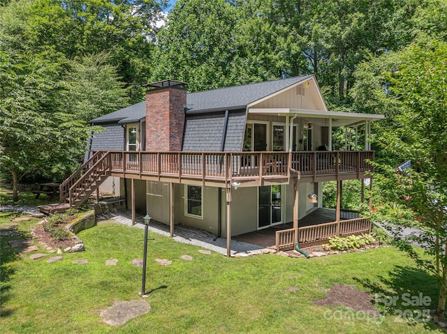 477 Locust Dr, Maggie Valley, NC 28751 - back of house with a yard, a chimney, a deck, a shingled roof, and stairway