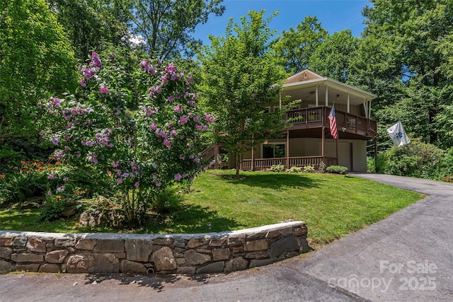 477 Locust Dr, Maggie Valley, NC 28751 - view of front of property featuring asphalt driveway, a front yard, an attached garage, and a balcony