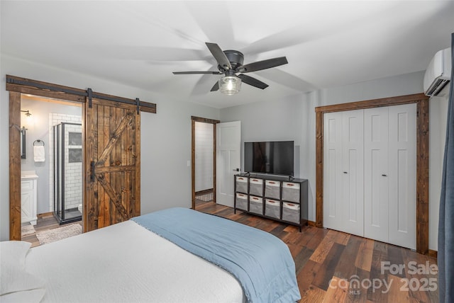 477 Locust Dr, Maggie Valley, NC 28751 - bedroom featuring a barn door, a wall mounted air conditioner, wood finished floors, a closet, and ceiling fan