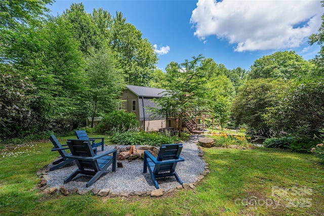 477 Locust Dr, Maggie Valley, NC 28751 - view of grassy yard with stairway, an outdoor fire pit, and a patio area