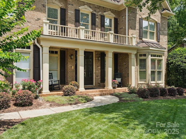 2103 Lytton Ln, Matthews, NC 28104 - view of front of house featuring a balcony, a porch, and brick siding