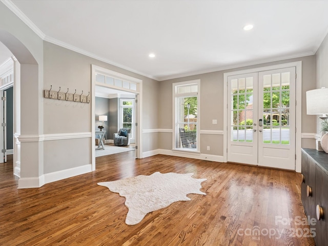 2103 Lytton Ln, Matthews, NC 28104 - unfurnished room featuring arched walkways, wood finished floors, french doors, ornamental molding, and recessed lighting