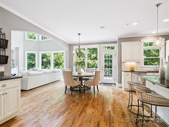 2103 Lytton Ln, Matthews, NC 28104 - dining area featuring light wood-style floors, ornamental molding, and recessed lighting