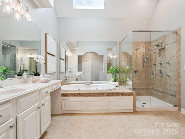 2103 Lytton Ln, Matthews, NC 28104 - full bath with a stall shower, a bath, vanity, a skylight, and tile patterned floors