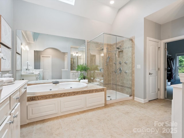 2103 Lytton Ln, Matthews, NC 28104 - bathroom featuring a garden tub, a stall shower, vanity, tile patterned floors, and vaulted ceiling