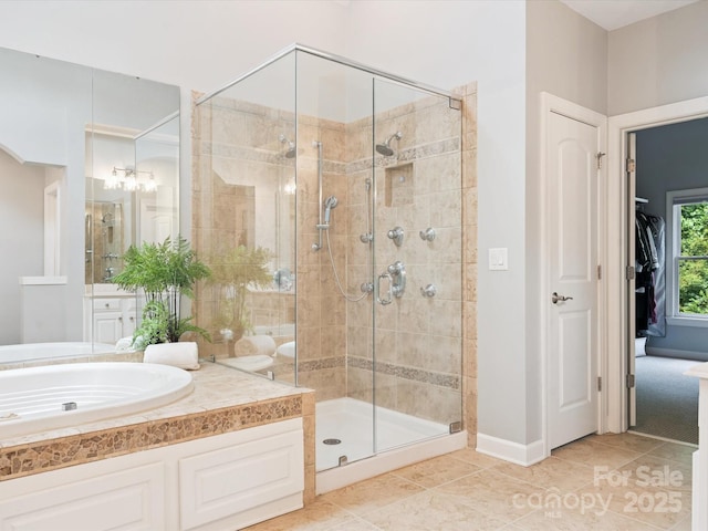 2103 Lytton Ln, Matthews, NC 28104 - bathroom featuring a shower stall, vanity, tile patterned floors, and a walk in closet