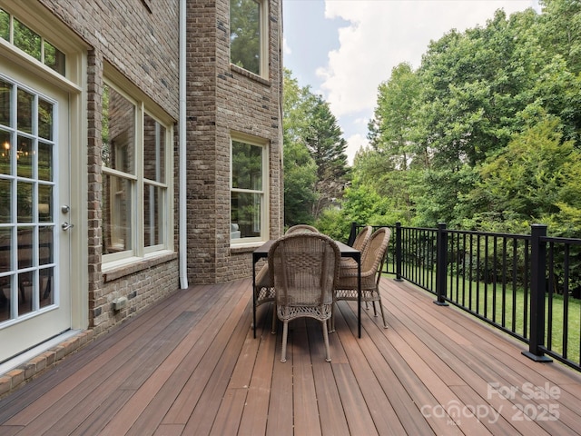 2103 Lytton Ln, Matthews, NC 28104 - wooden deck featuring outdoor dining area and view of wooded area