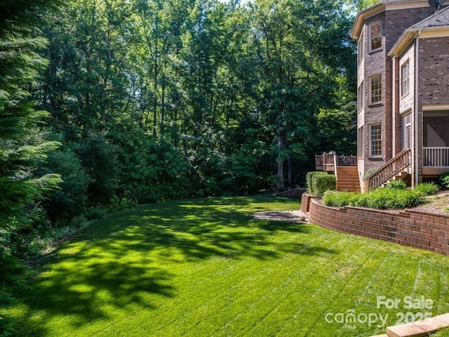 2103 Lytton Ln, Matthews, NC 28104 - view of grassy yard featuring stairs and a wooden deck