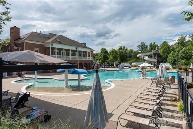 2103 Lytton Ln, Matthews, NC 28104 - community pool featuring a water slide and a patio