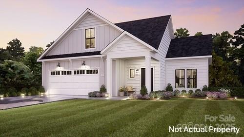 7548 Baybrooke Ln Unit 26, Harrisburg, NC 28075 - modern farmhouse style home featuring board and batten siding, driveway, a garage, and a front yard