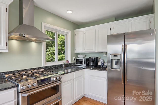 600 Summit Rdg Unit 34, Waynesville, NC 28786 - kitchen featuring appliances with stainless steel finishes, wall chimney exhaust hood, white cabinetry, dark stone countertops, and recessed lighting