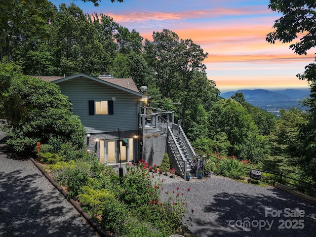 600 Summit Rdg Unit 34, Waynesville, NC 28786 - view of front facade featuring stairs, a wooden deck, and a shingled roof