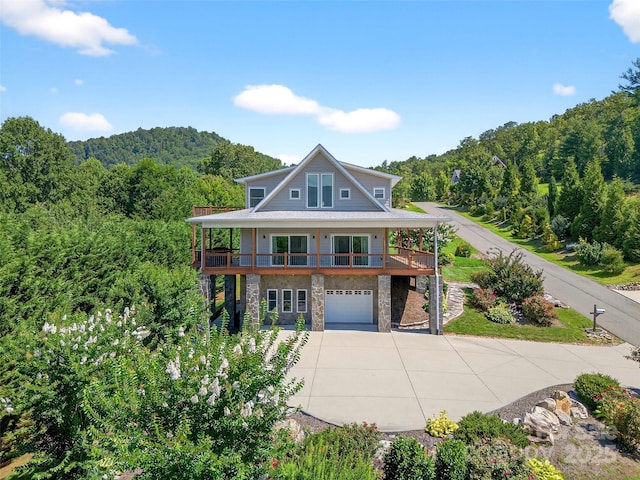 4 Stars Forever Dr, Black Mountain, NC 28711 - view of front of property with driveway, stone siding, an attached garage, a view of trees, and a porch