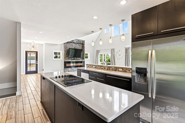 4 Stars Forever Dr, Black Mountain, NC 28711 - kitchen with stainless steel fridge, black electric cooktop, light countertops, open floor plan, and a chandelier